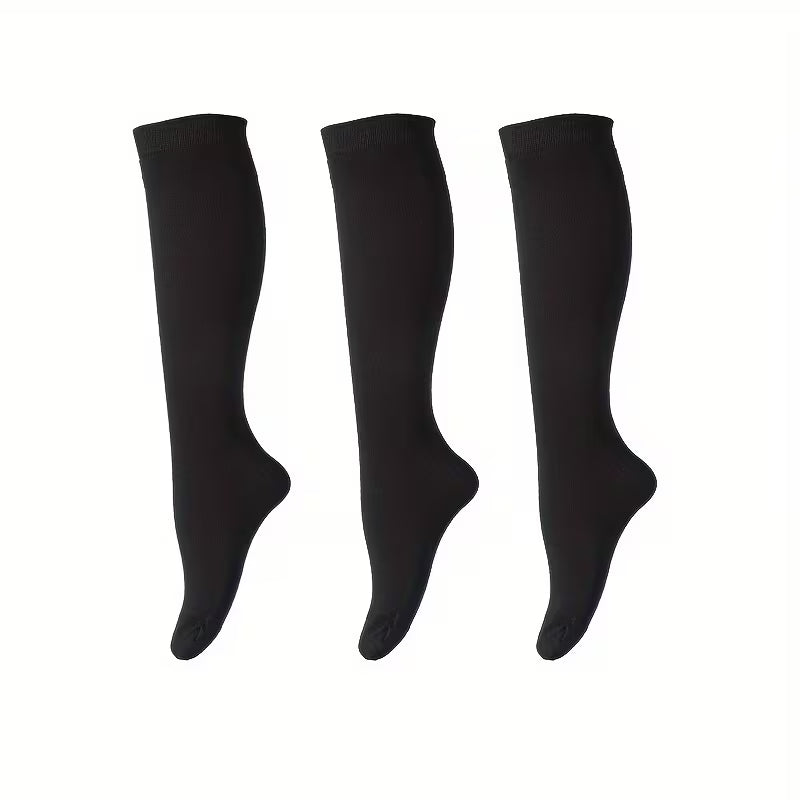 Three black knee-high socks on a white background